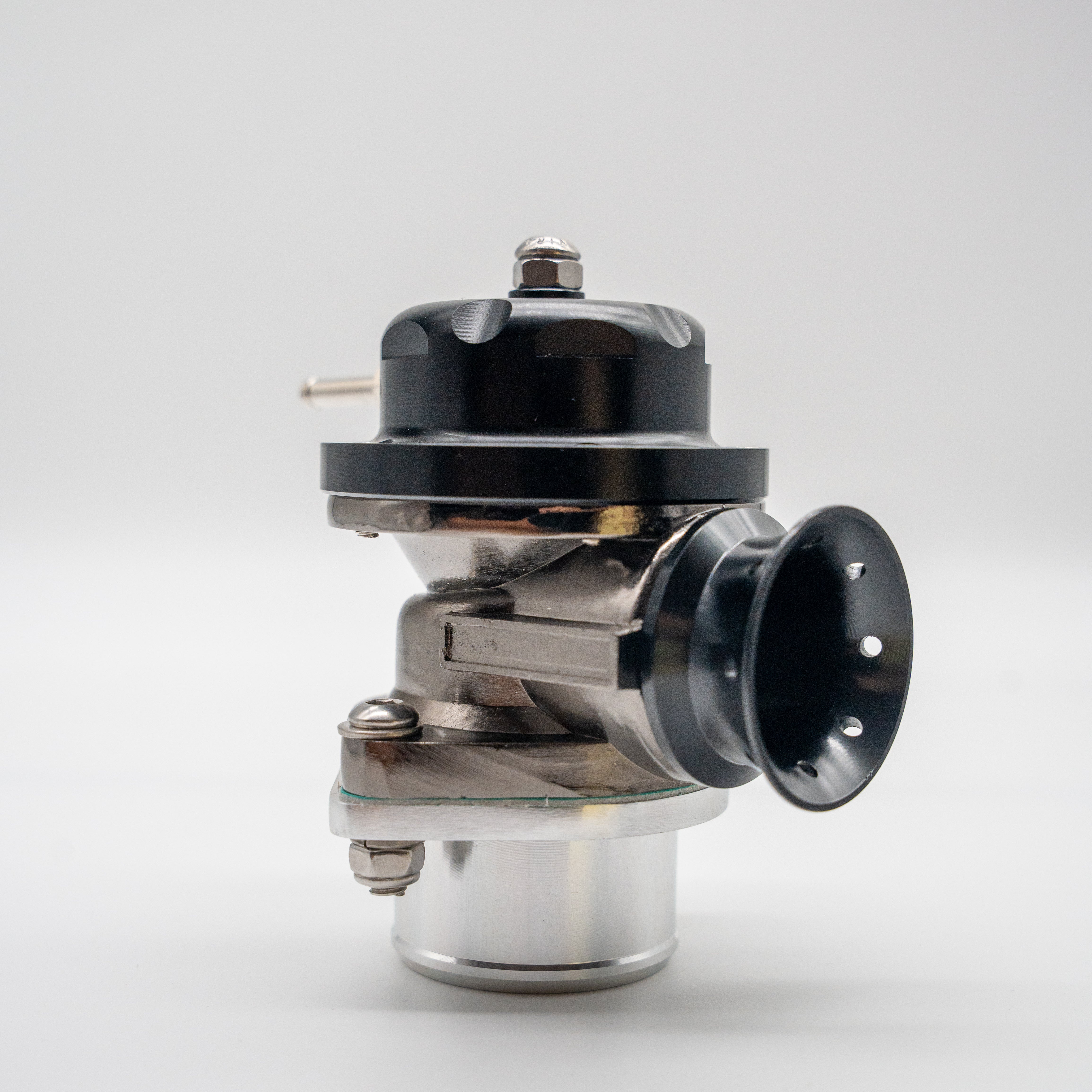 A high-performance automotive tuning component, likely a Blow off valve, featuring a glossy black anodized top cap, a black venturi-style nozzle, and a polished silver aluminum base, photographed on a seamless light gray background.