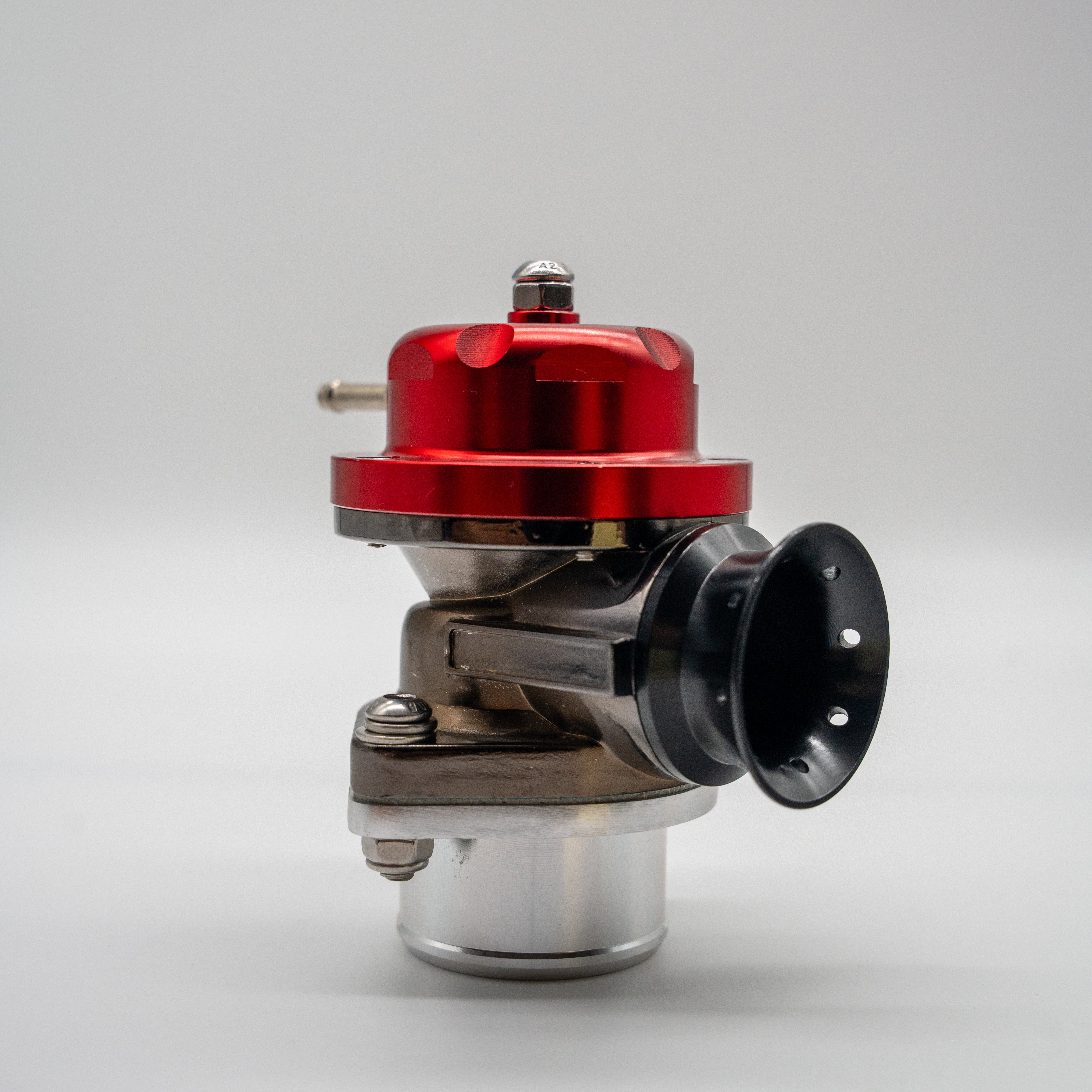 A high-performance automotive tuning component, likely a Blow off valve, featuring a glossy red anodized top cap, a black venturi-style nozzle, and a polished silver aluminum base, photographed on a seamless light gray background.